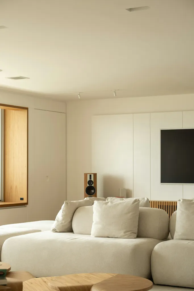 A living room in a warm palette of oak and linen