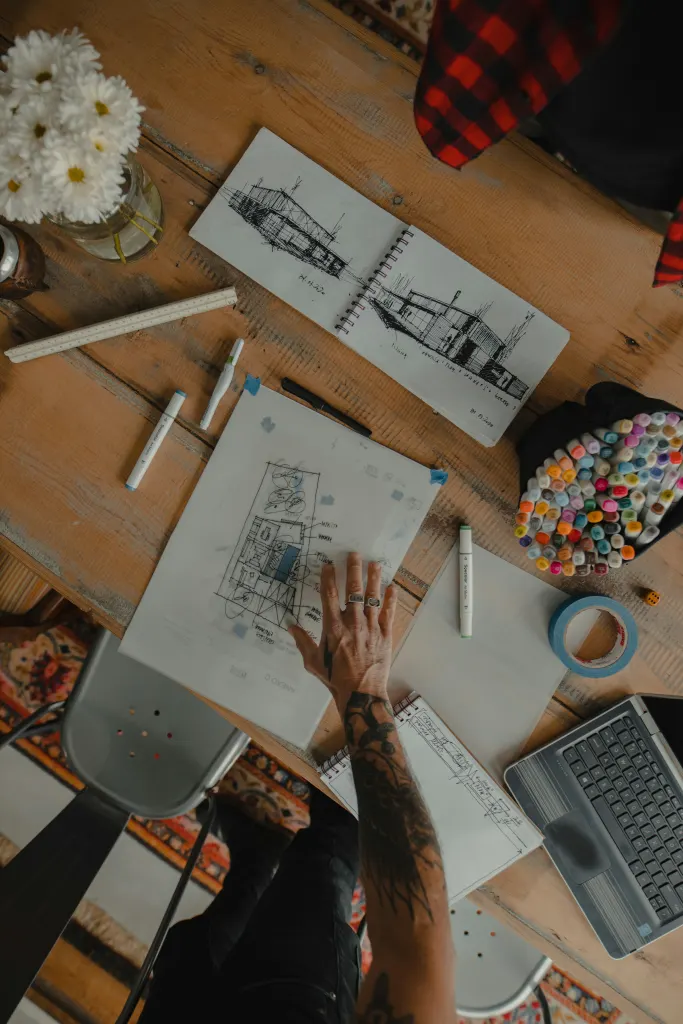 Furniture sketches and plans spread on the work table