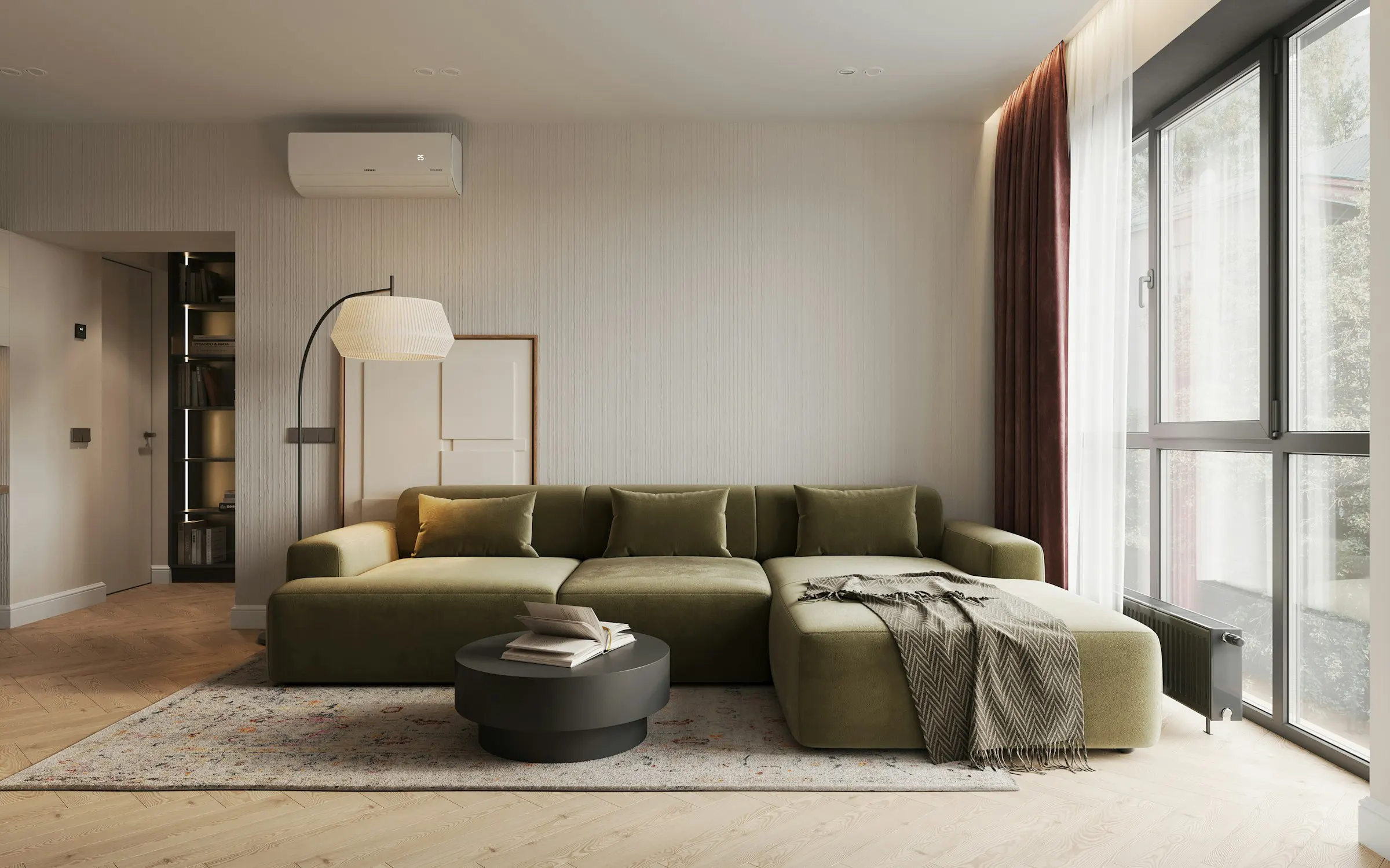 A living room with a green velvet sofa and natural light