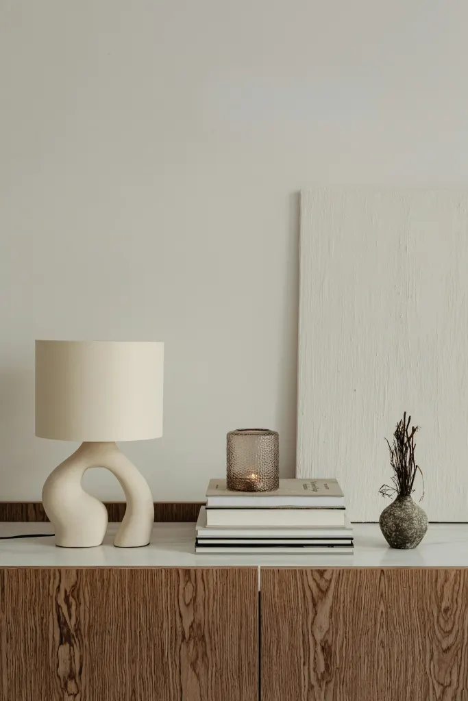 A lamp and a stack of books on a table
