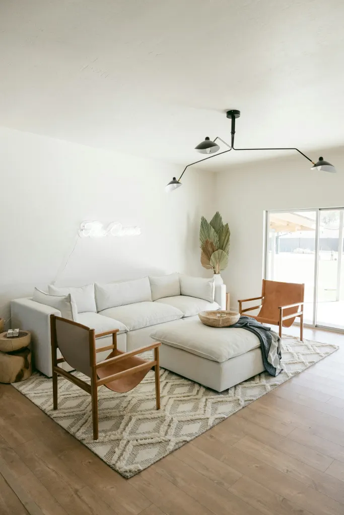 A white sofa beside an oak chair