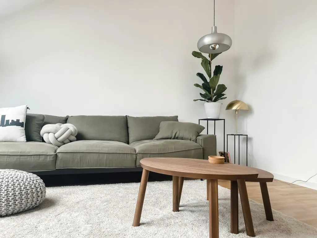 A low grey sofa and an oak coffee table