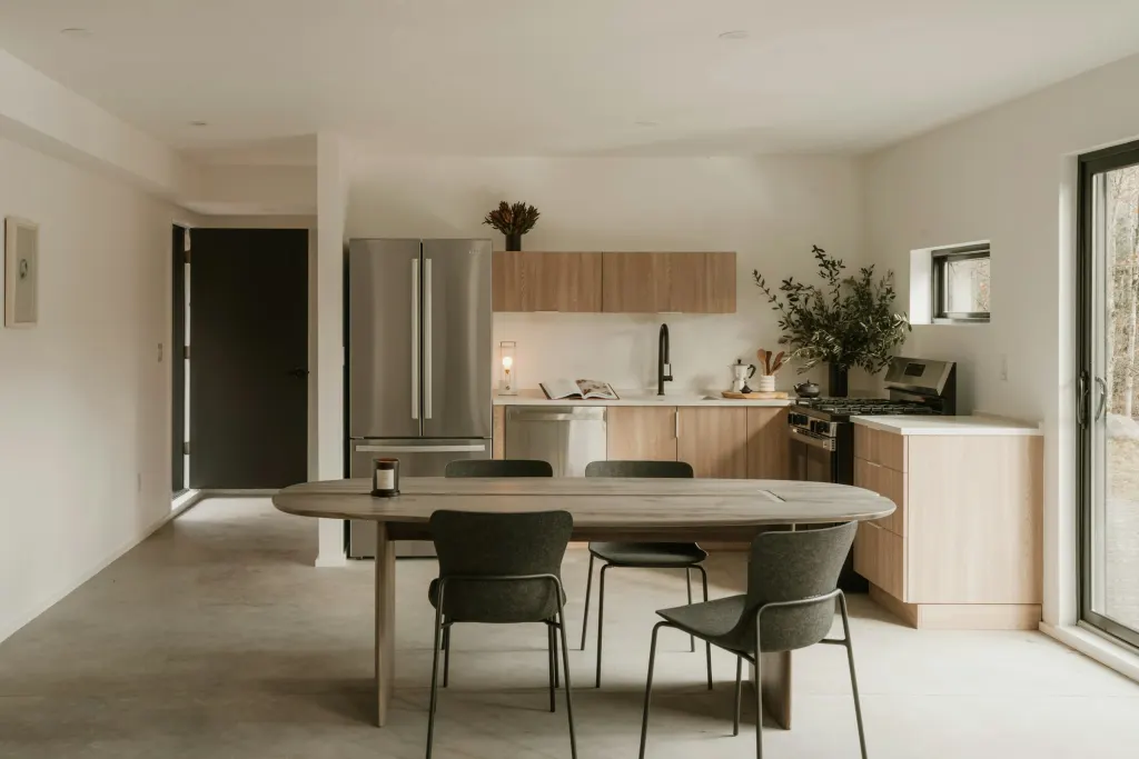 A kitchen and dining room with a wooden table