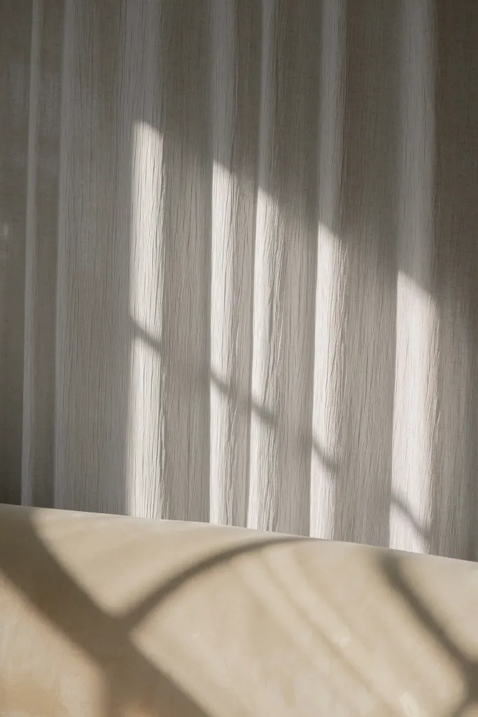 Linen curtains and the shadows of a window