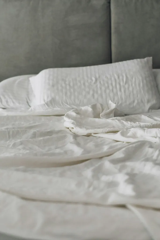 A bed made with white linen